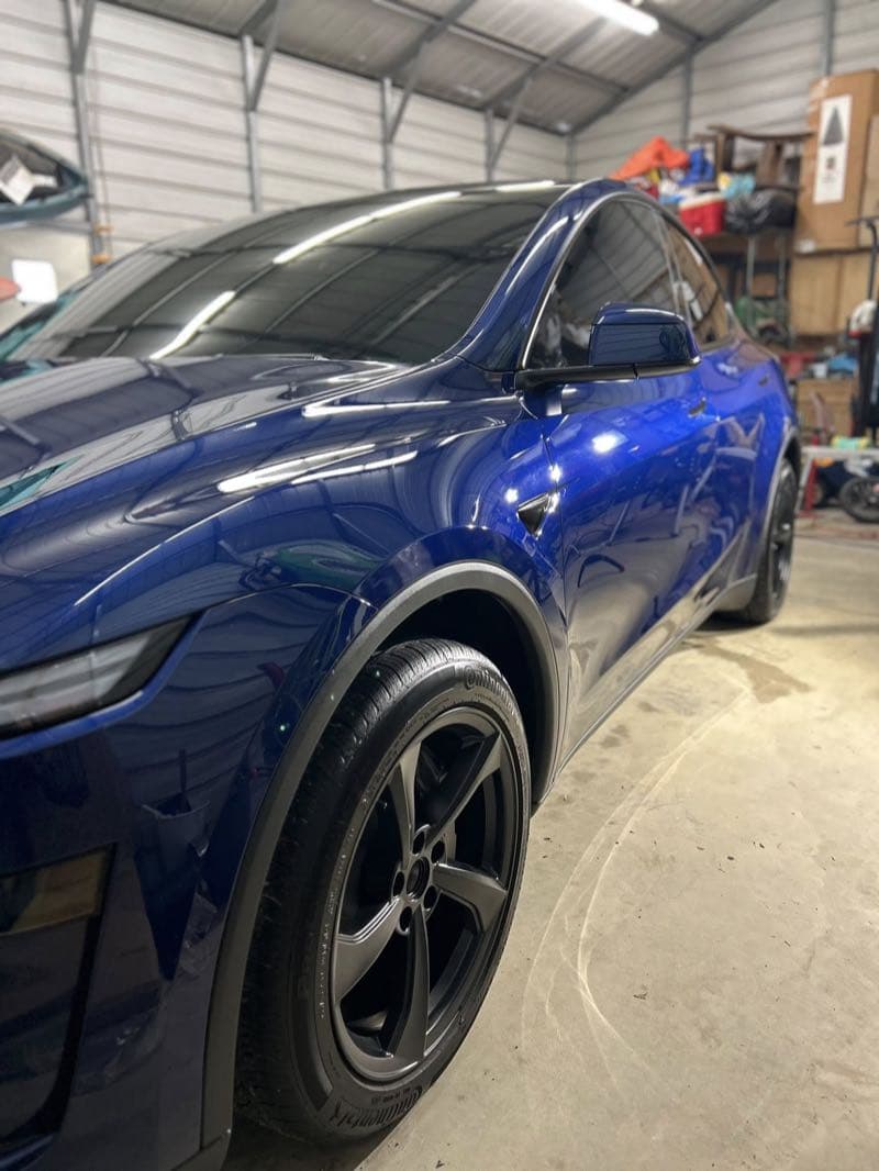 Blue Tesla with restored trim and glossy paint