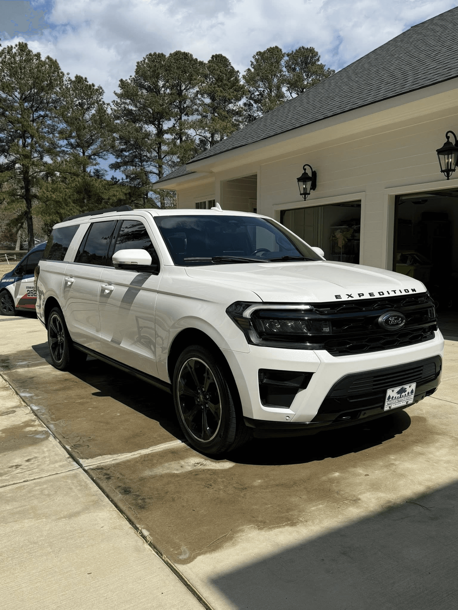 White Ford Expedition freshly detailed in driveway