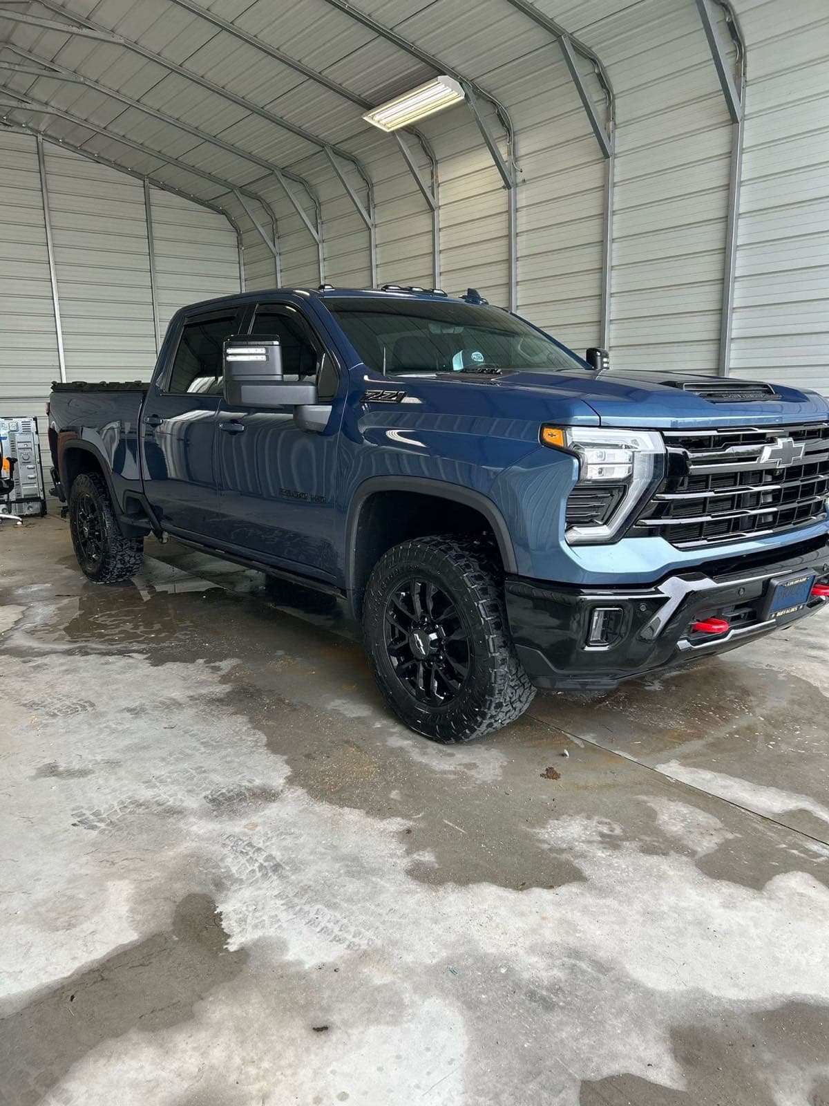 Blue Chevy Silverado 2500 HD detailed under carport
