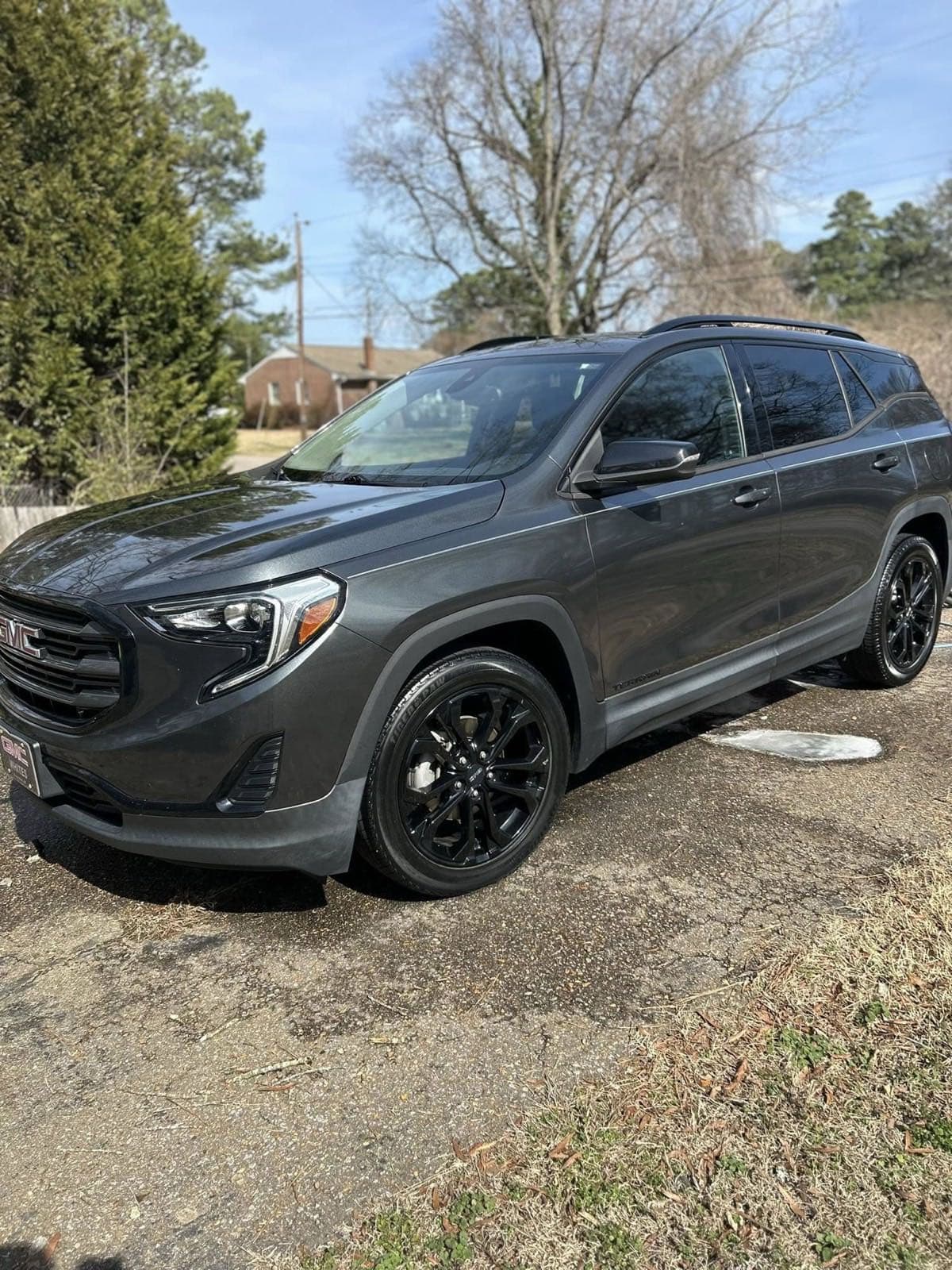 Gray GMC Terrain exterior detail with clean black wheels
