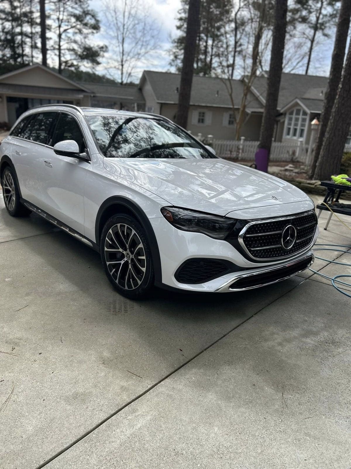 White Mercedes-Benz SUV detailed with glossy paint finish in driveway
