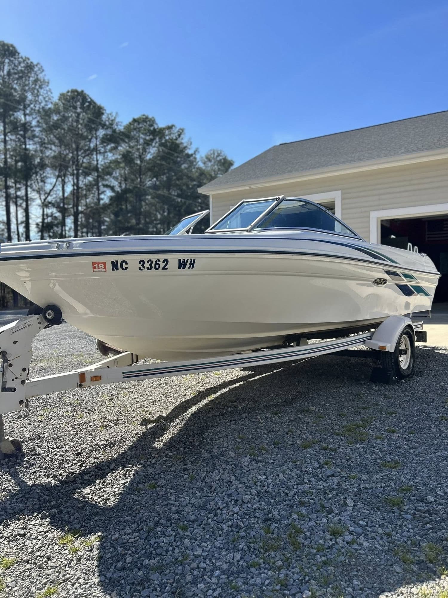 Freshly detailed white Sea Ray boat on trailer with polished gel coat in Roanoke Rapids NC