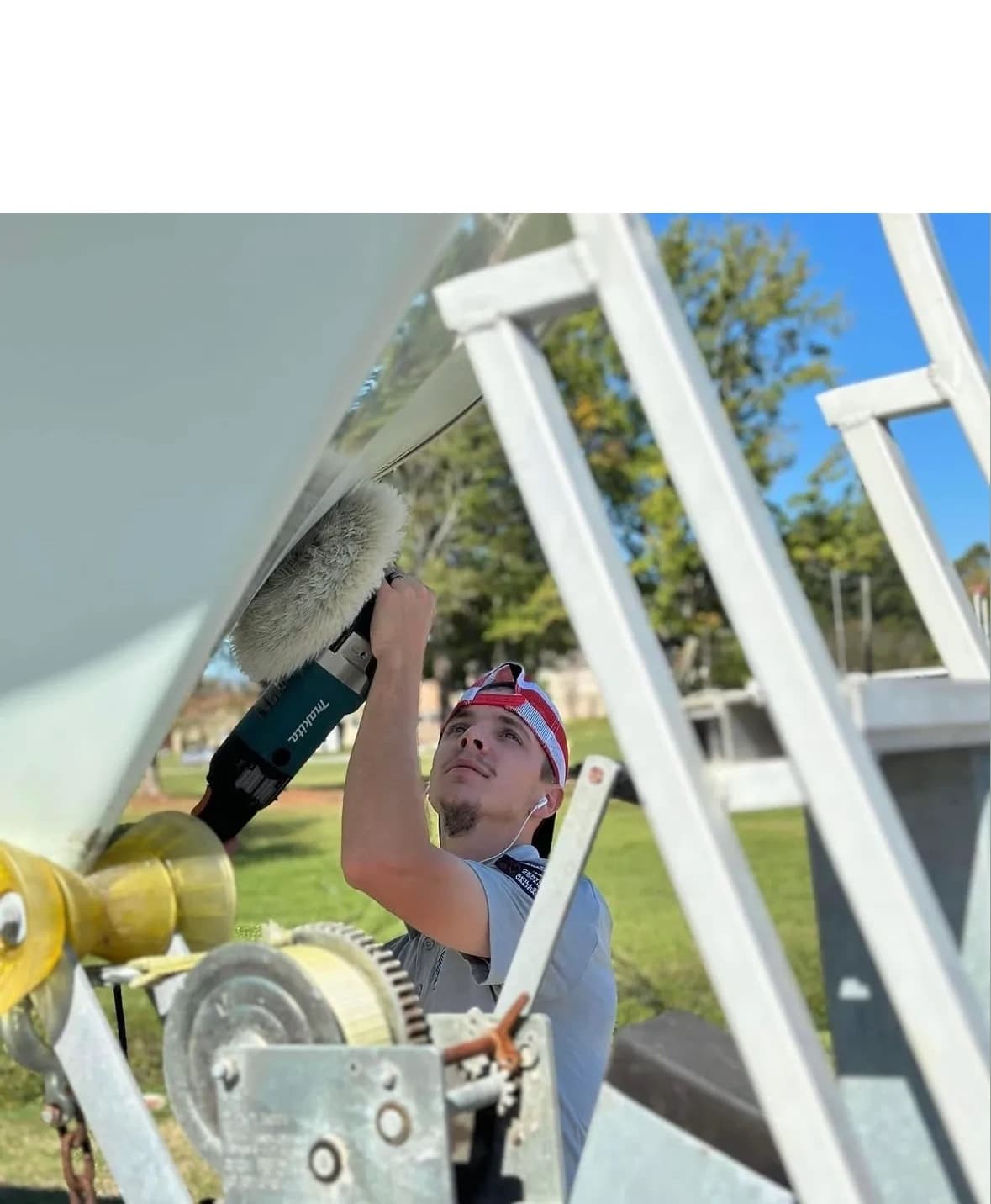 Cody Umphlett detailing a boat at Discount Detailing